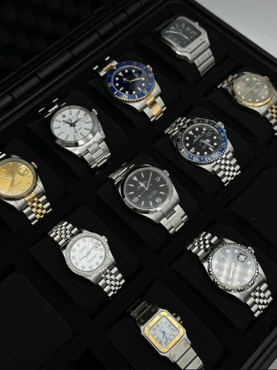 A presentation case of watches, blue, black and champagne dials side by side
